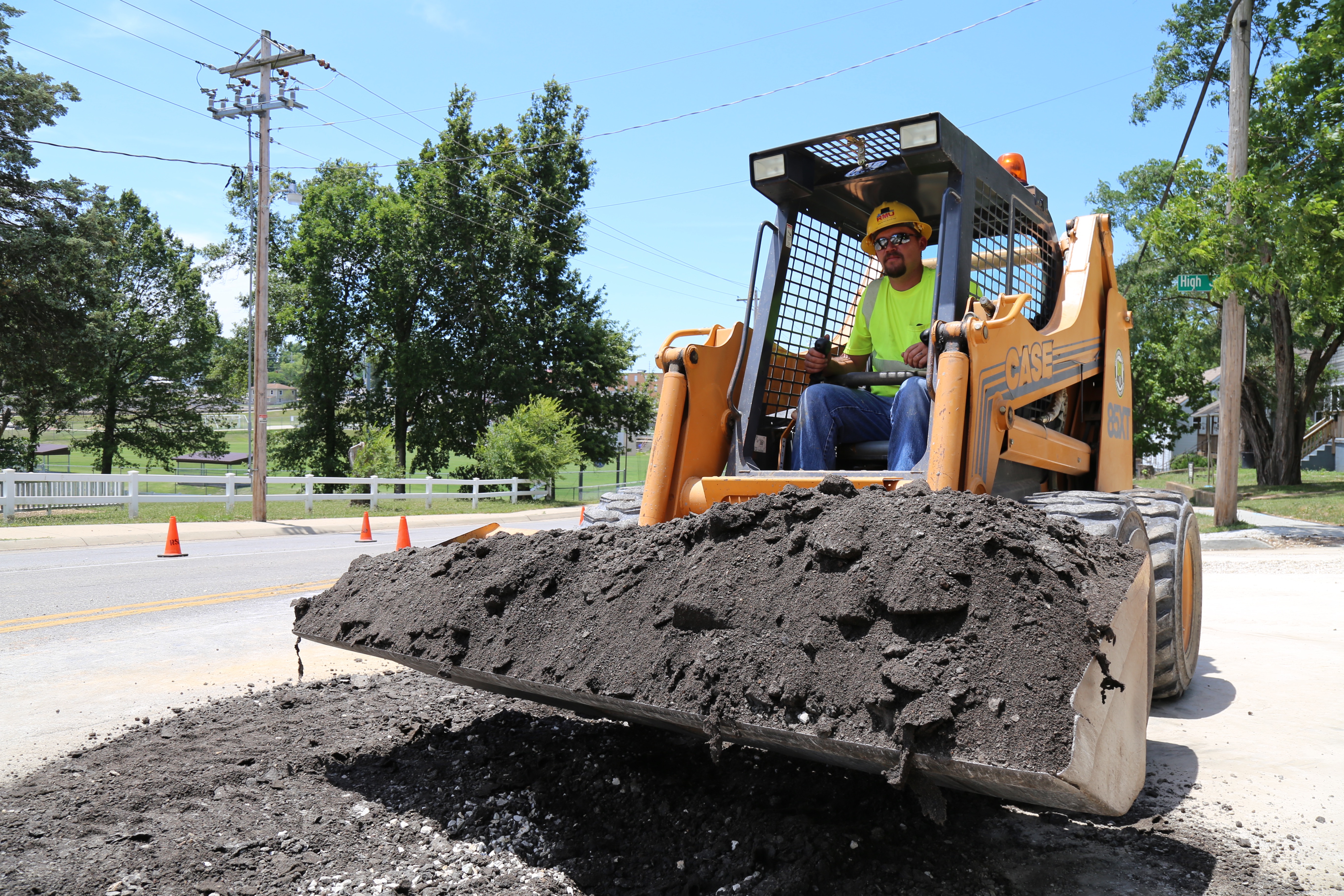 A utility worker from Rolla Municipal Utilities clears debris.